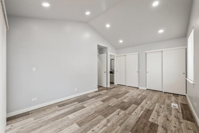43 S Treehouse Ln, Round Lake, IL 60073 - unfurnished bedroom with multiple closets, baseboards, recessed lighting, and vaulted ceiling