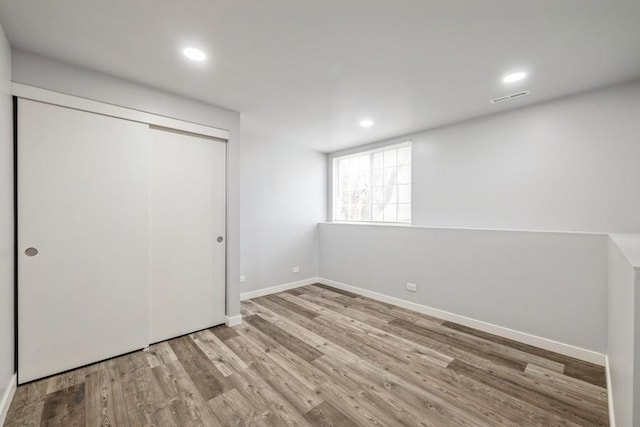 43 S Treehouse Ln, Round Lake, IL 60073 - unfurnished bedroom featuring baseboards, wood finished floors, visible vents, and recessed lighting
