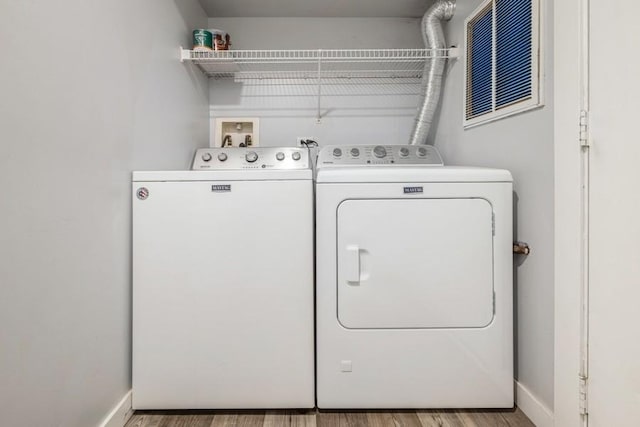 43 S Treehouse Ln, Round Lake, IL 60073 - clothes washing area with washing machine and dryer, wood finished floors, baseboards, and laundry area