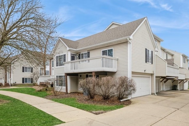 43 S Treehouse Ln, Round Lake, IL 60073 - view of front facade featuring concrete driveway, a front yard, a balcony, and a garage