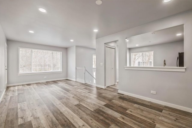 43 S Treehouse Ln, Round Lake, IL 60073 - unfurnished living room with wood finished floors, baseboards, and recessed lighting