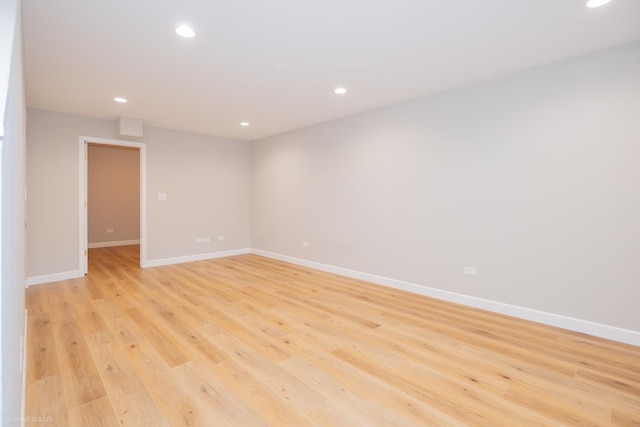 spare room featuring recessed lighting, baseboards, and light wood finished floors