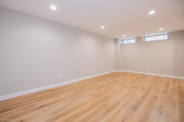 below grade area with light wood-style floors and recessed lighting