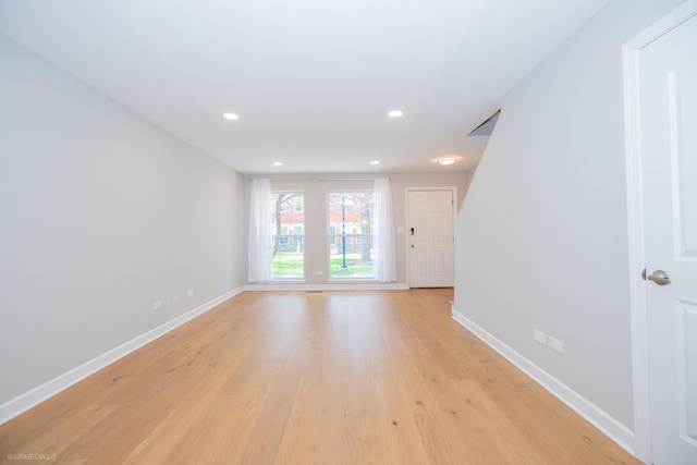 spare room featuring recessed lighting, baseboards, and light wood-style floors