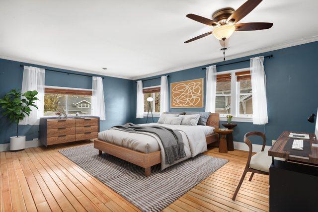 bedroom featuring baseboards, crown molding, and light wood-style flooring