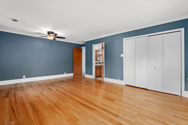 unfurnished bedroom featuring light wood finished floors, ensuite bathroom, baseboards, ceiling fan, and ornamental molding