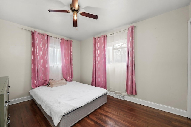 bedroom featuring visible vents, wood finished floors, baseboards, and ceiling fan