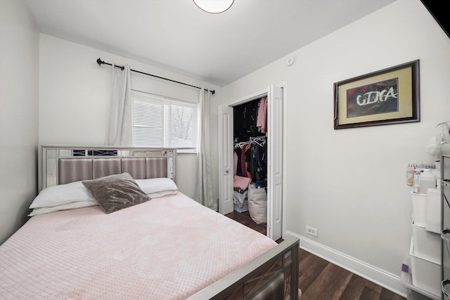 bedroom featuring baseboards, dark wood-style floors, and a closet