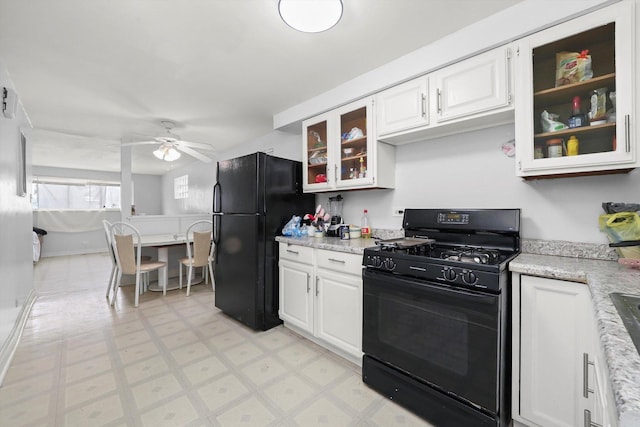 kitchen with white cabinets, glass insert cabinets, a ceiling fan, and black appliances