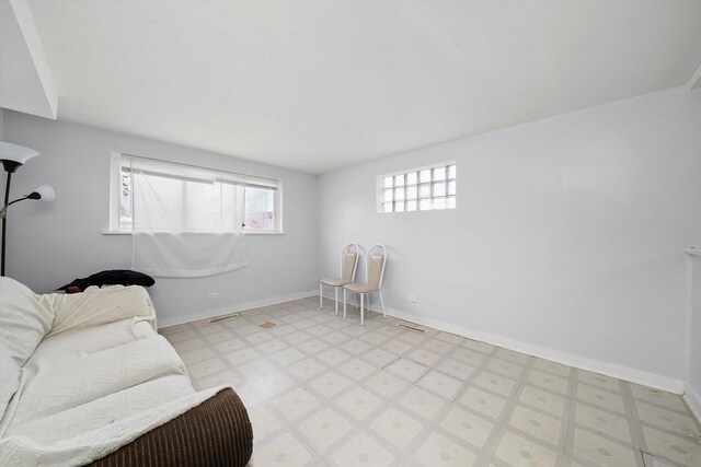 sitting room with light floors, baseboards, and visible vents