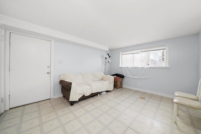 sitting room featuring light floors and baseboards