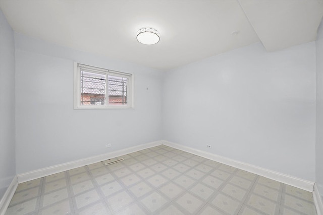 unfurnished room featuring visible vents, baseboards, and light floors
