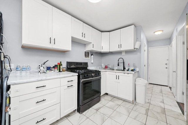 kitchen featuring white cabinets, a sink, visible vents, gas stove, and marble finish floor
