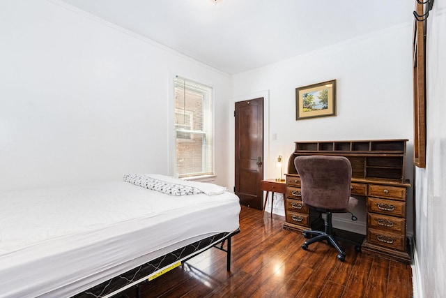 bedroom with dark wood-style flooring and crown molding