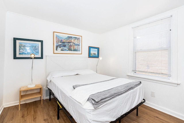 bedroom featuring visible vents, baseboards, lofted ceiling, and light wood-type flooring