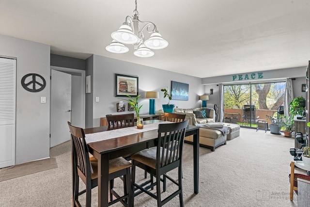 3350 N Carriageway Dr Unit 217, Arlington Heights, IL 60004 - dining area with carpet floors and an inviting chandelier