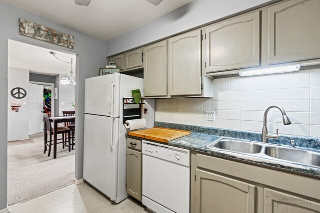 3350 N Carriageway Dr Unit 217, Arlington Heights, IL 60004 - kitchen featuring a sink, dark countertops, backsplash, and white appliances