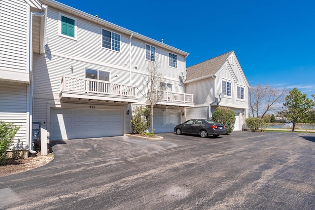 573 S Rosehall Ln Unit 0, Round Lake, IL 60073 - back of property with aphalt driveway and an attached garage