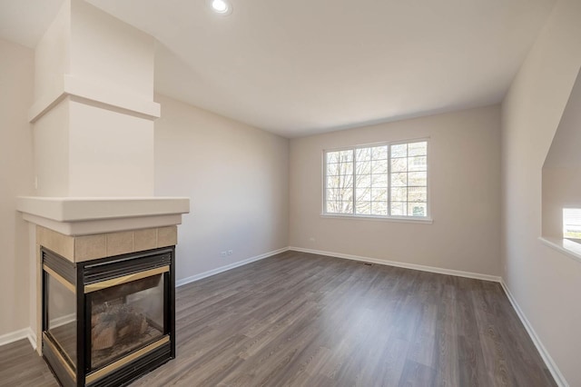 573 S Rosehall Ln Unit 0, Round Lake, IL 60073 - unfurnished living room featuring recessed lighting, a tile fireplace, dark wood-style flooring, and baseboards