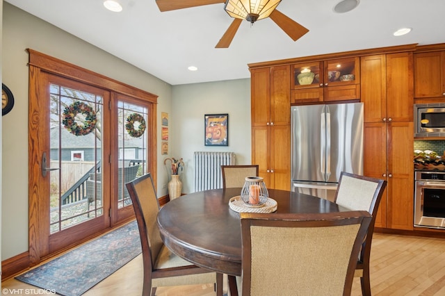dining space with recessed lighting, light wood-style floors, ceiling fan, and radiator
