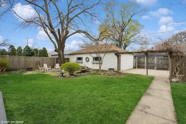 view of yard featuring a fire pit, fence, and a patio