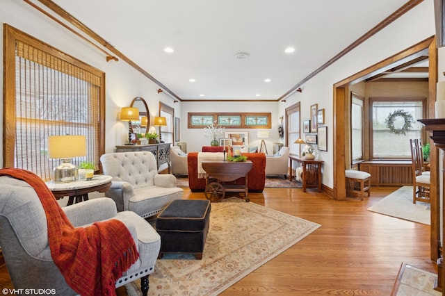 living area with recessed lighting, light wood-style flooring, and ornamental molding
