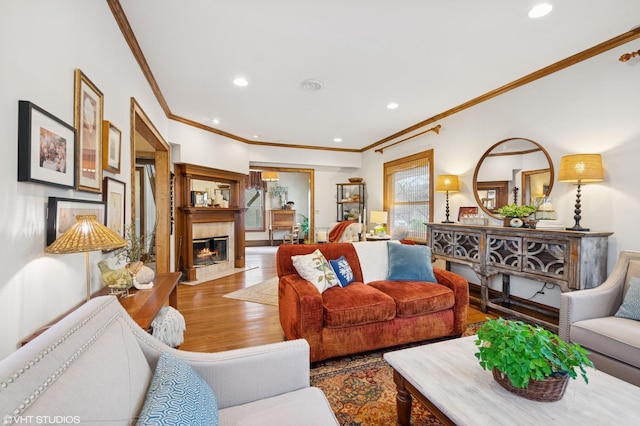 living room featuring wood finished floors, recessed lighting, and ornamental molding