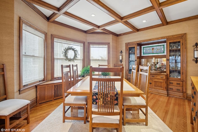 dining area with coffered ceiling, light wood-style floors, and beamed ceiling