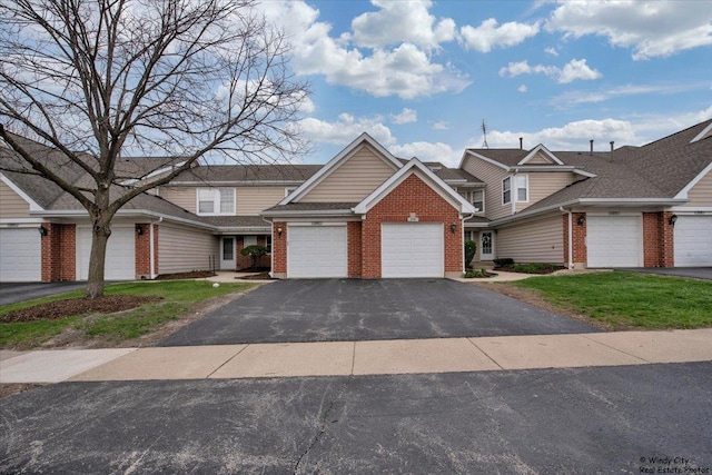 multi unit property featuring aphalt driveway, roof with shingles, brick siding, a front lawn, and an attached garage
