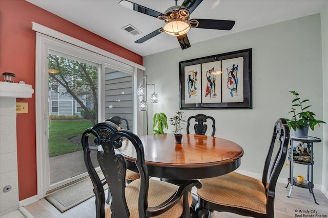 dining space with light wood-style floors, baseboards, ceiling fan, and visible vents