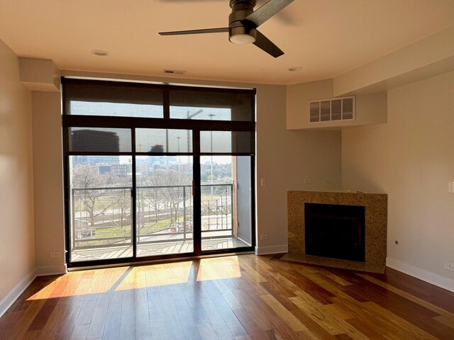 651 N Milwaukee Ave Unit 403, Chicago, IL 60642 - unfurnished living room with visible vents, wood finished floors, a ceiling fan, and plenty of natural light