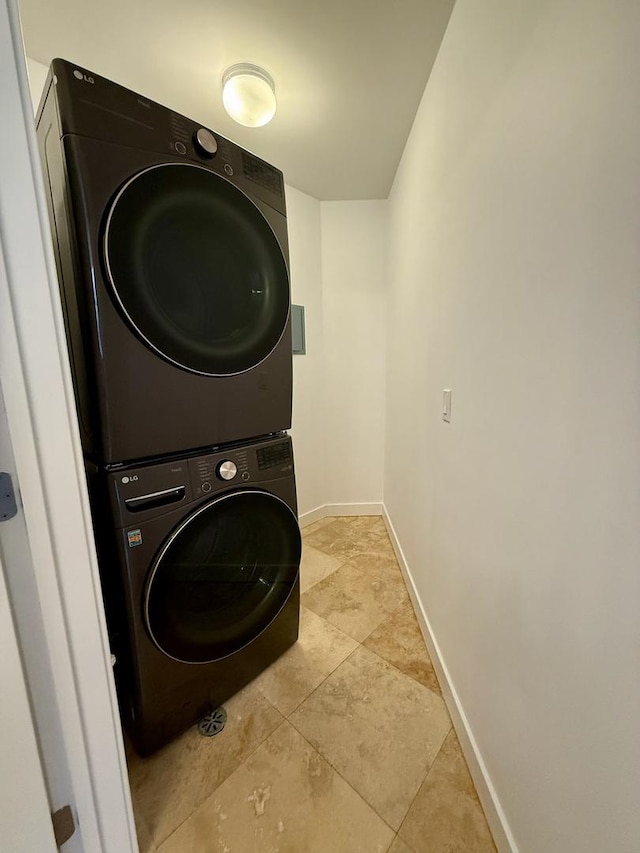 651 N Milwaukee Ave Unit 403, Chicago, IL 60642 - washroom with stacked washer and clothes dryer, laundry area, and baseboards