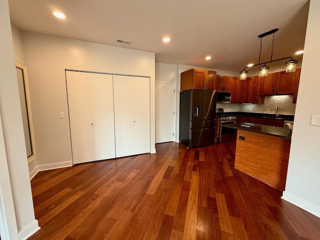 651 N Milwaukee Ave Unit 403, Chicago, IL 60642 - kitchen with a sink, appliances with stainless steel finishes, visible vents, dark countertops, and backsplash