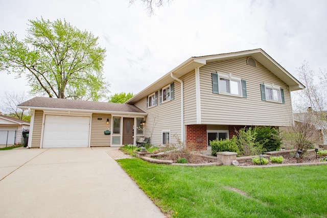 tri-level home featuring a garage, driveway, and a front yard