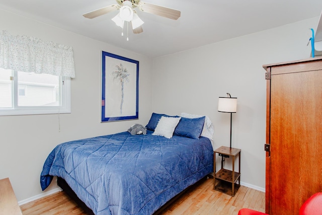 bedroom with baseboards, ceiling fan, and wood finished floors