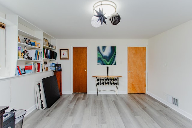 living room featuring light wood-type flooring and visible vents