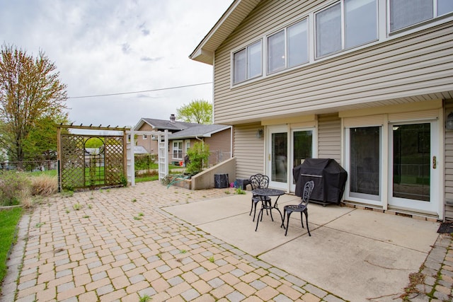 view of patio / terrace with area for grilling and fence
