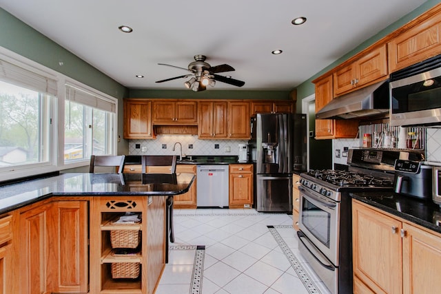 kitchen featuring appliances with stainless steel finishes, tasteful backsplash, open shelves, under cabinet range hood, and light tile patterned flooring