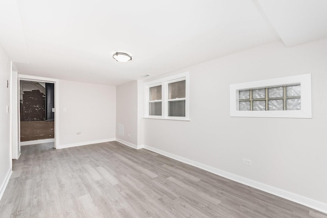 empty room with baseboards and wood finished floors
