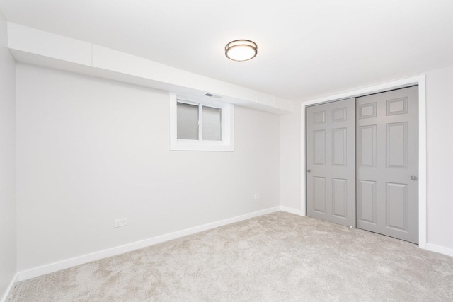 unfurnished bedroom featuring baseboards, a closet, and carpet