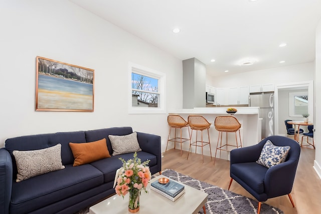 living area with recessed lighting and light wood-type flooring
