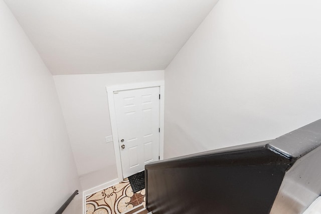 unfurnished office with lofted ceiling and baseboards