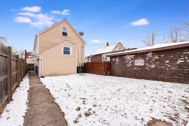 snow covered property featuring fence