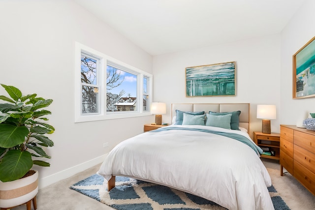 bedroom featuring baseboards and carpet flooring
