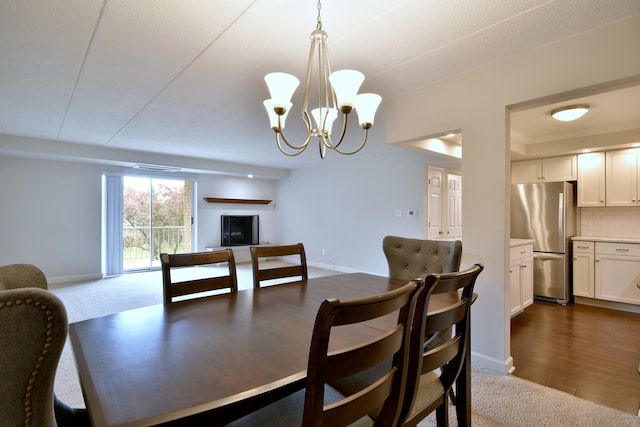 110 W Butterfield Rd Unit 214S, Elmhurst, IL 60126 - dining area with baseboards, a notable chandelier, and dark carpet