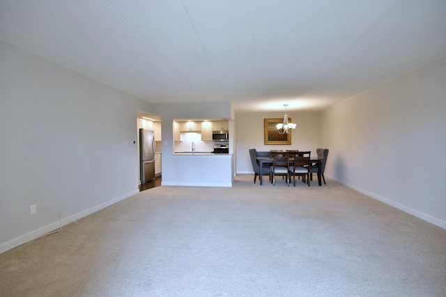 110 W Butterfield Rd Unit 214S, Elmhurst, IL 60126 - living area featuring an inviting chandelier, baseboards, and light carpet