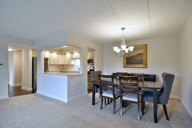 110 W Butterfield Rd Unit 214S, Elmhurst, IL 60126 - carpeted dining space featuring an inviting chandelier, a sink, and baseboards