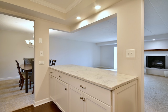 110 W Butterfield Rd Unit 214S, Elmhurst, IL 60126 - kitchen featuring crown molding, light stone countertops, recessed lighting, baseboards, and a peninsula