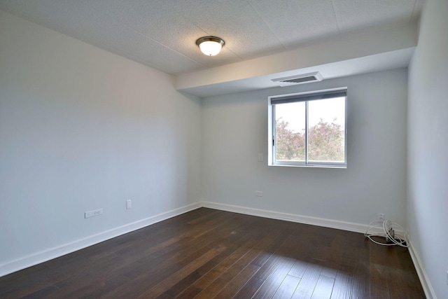 110 W Butterfield Rd Unit 214S, Elmhurst, IL 60126 - empty room with visible vents, a textured ceiling, dark wood-style flooring, and baseboards