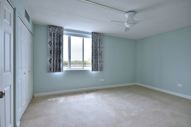 110 W Butterfield Rd Unit 214S, Elmhurst, IL 60126 - unfurnished bedroom featuring carpet floors, a ceiling fan, baseboards, and a closet